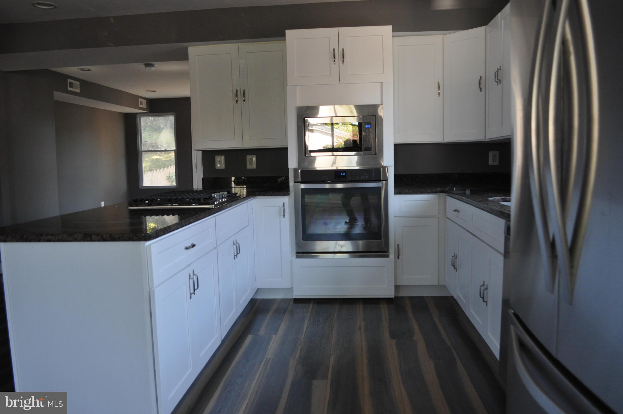 4909 Fitch Place Northeast Washington, DC 20019 - Photo 11 of 30 a kitchen with granite countertop a refrigerator and a sink