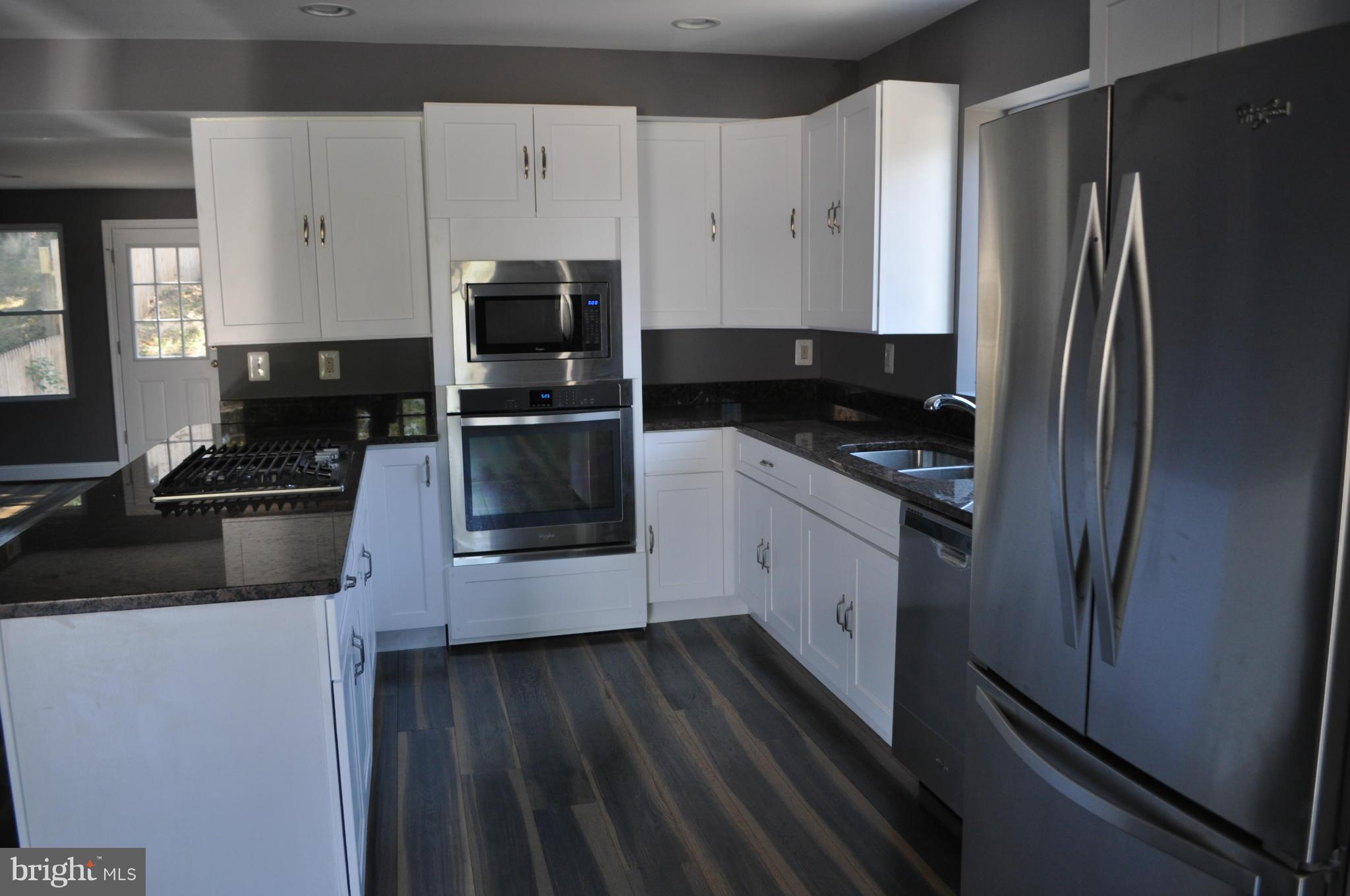 4909 Fitch Place Northeast Washington, DC 20019 - Photo 14 of 30 a kitchen with granite countertop a refrigerator stove and sink