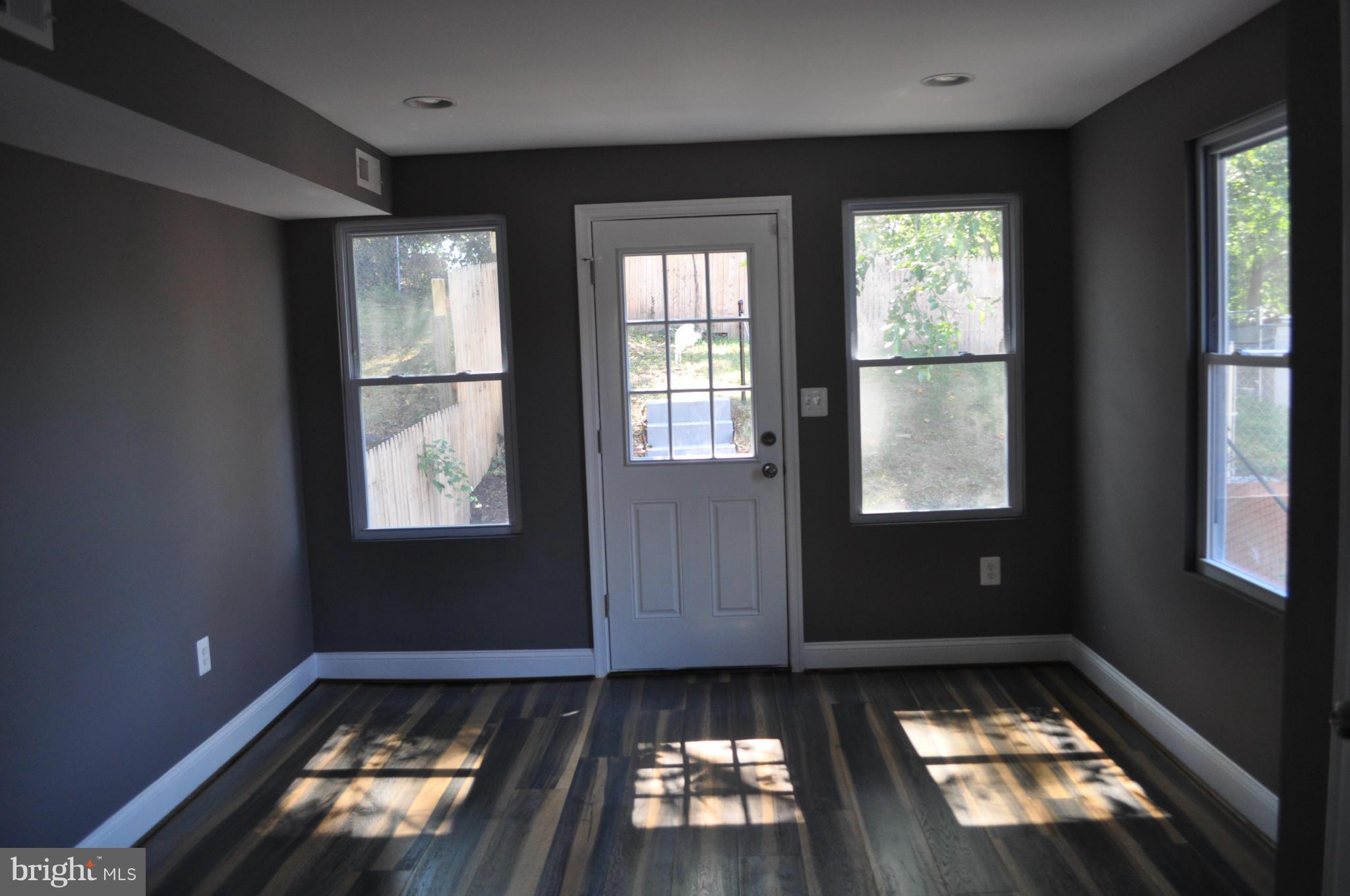 4909 Fitch Place Northeast Washington, DC 20019 - Photo 15 of 30 an empty room with wooden floor and windows
