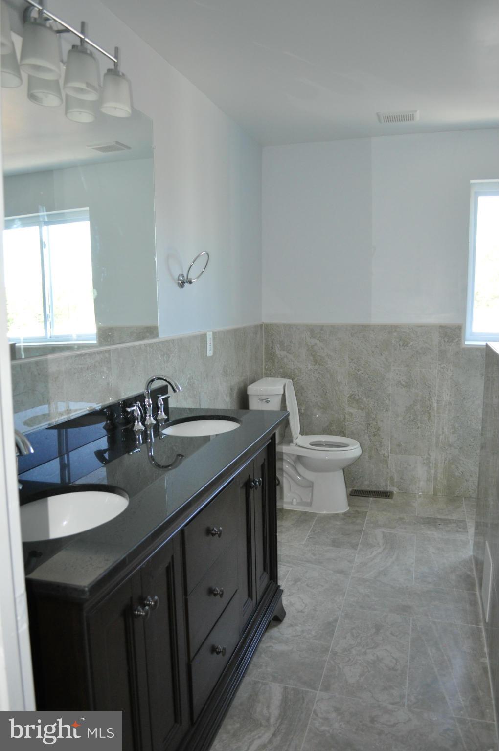 4909 Fitch Place Northeast Washington, DC 20019 - Photo 22 of 30 a bathroom with a double vanity sink and a toilet