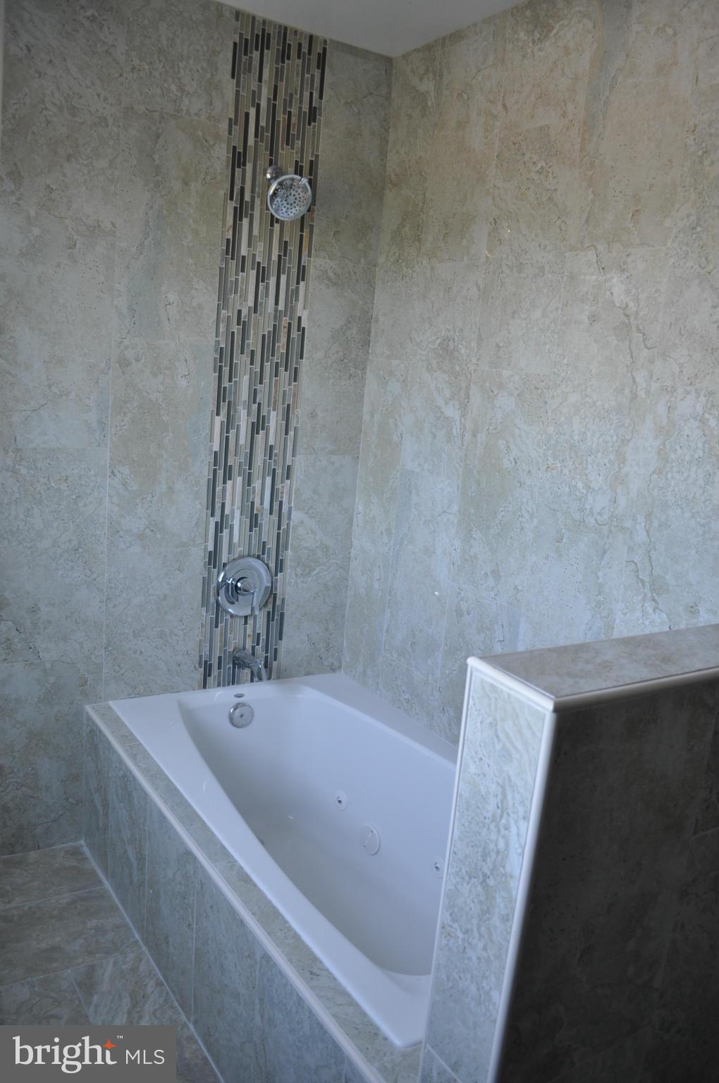 4909 Fitch Place Northeast Washington, DC 20019 - Photo 23 of 30 a bathroom with a bathtub and shower