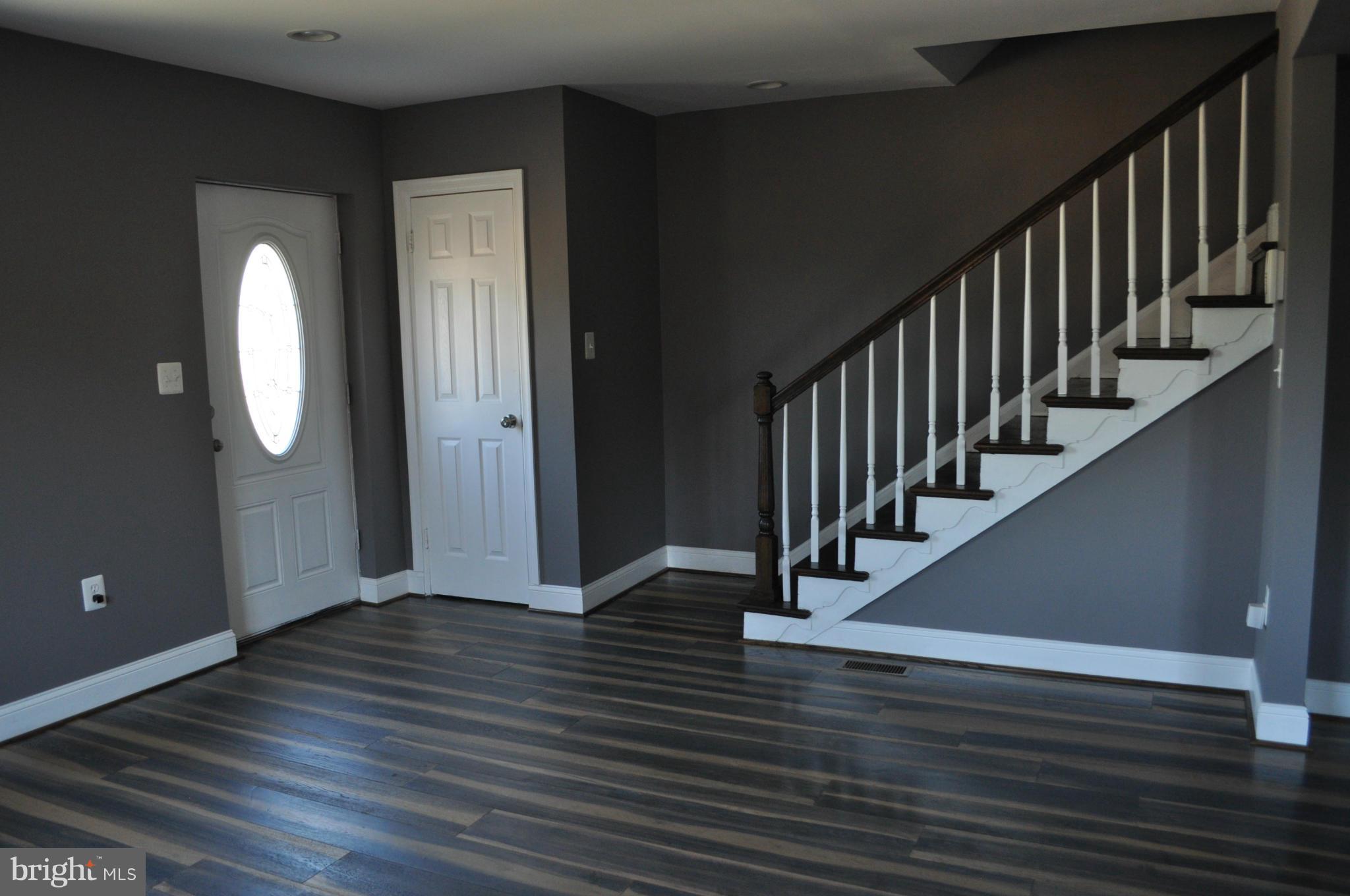 4909 Fitch Place Northeast Washington, DC 20019 - Photo 8 of 30 a view of a hallway with wooden floor and staircase