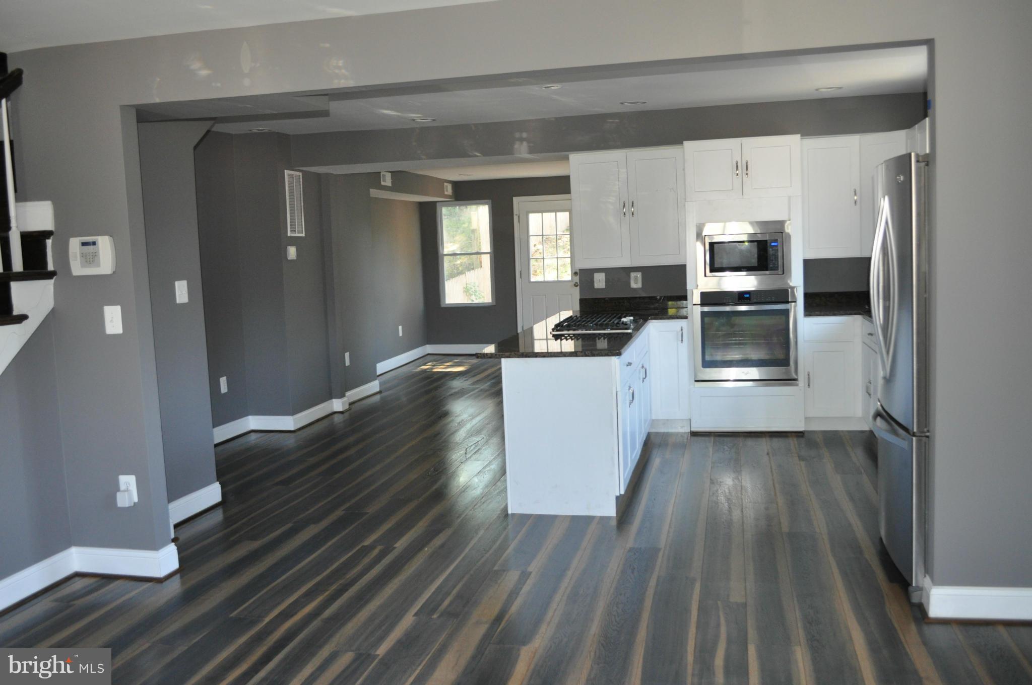 4909 Fitch Place Northeast Washington, DC 20019 - Photo 9 of 30 a kitchen with wooden floors and refrigerator