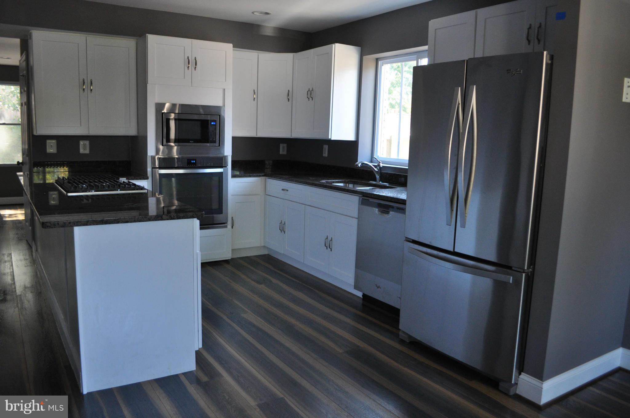 4909 Fitch Place Northeast Washington, DC 20019 - Photo 10 of 30 a kitchen with stainless steel appliances a refrigerator sink and microwave