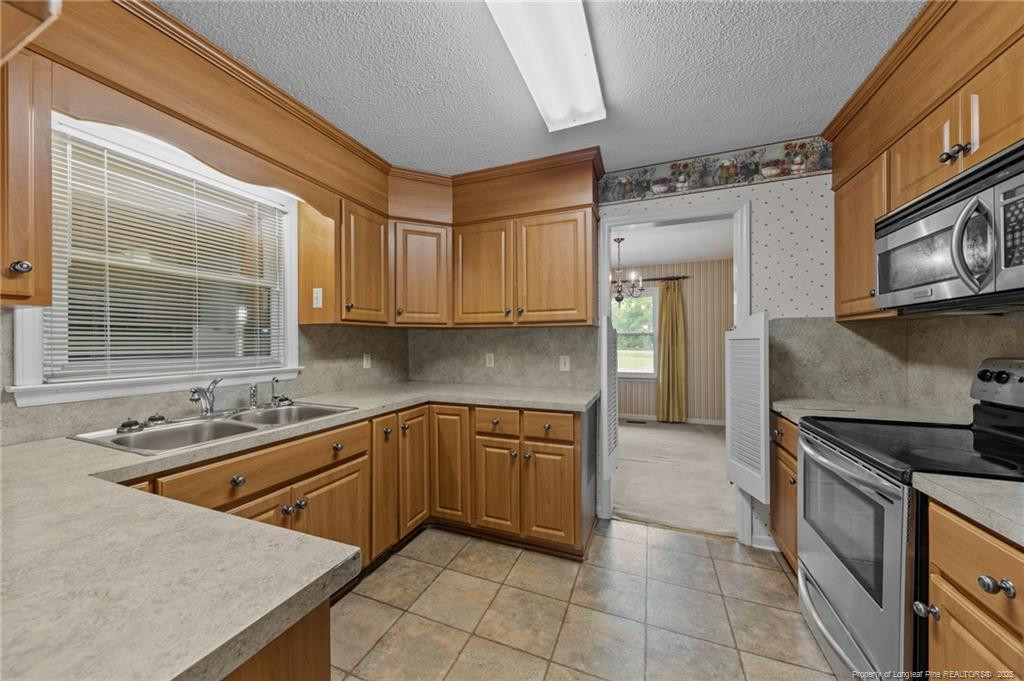 241 Hight Road Aberdeen, NC 28315 - Photo 11 of 48 a kitchen with stainless steel appliances granite countertop a sink stove and cabinets
