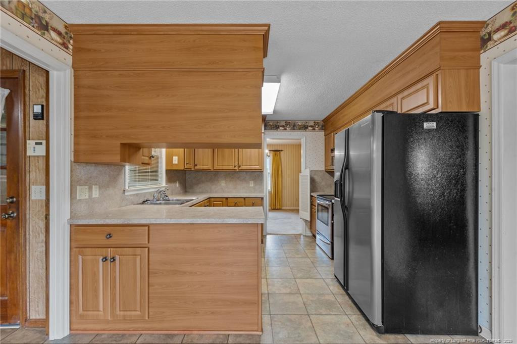241 Hight Road Aberdeen, NC 28315 - Photo 12 of 48 a kitchen with stainless steel appliances granite countertop a refrigerator and a stove