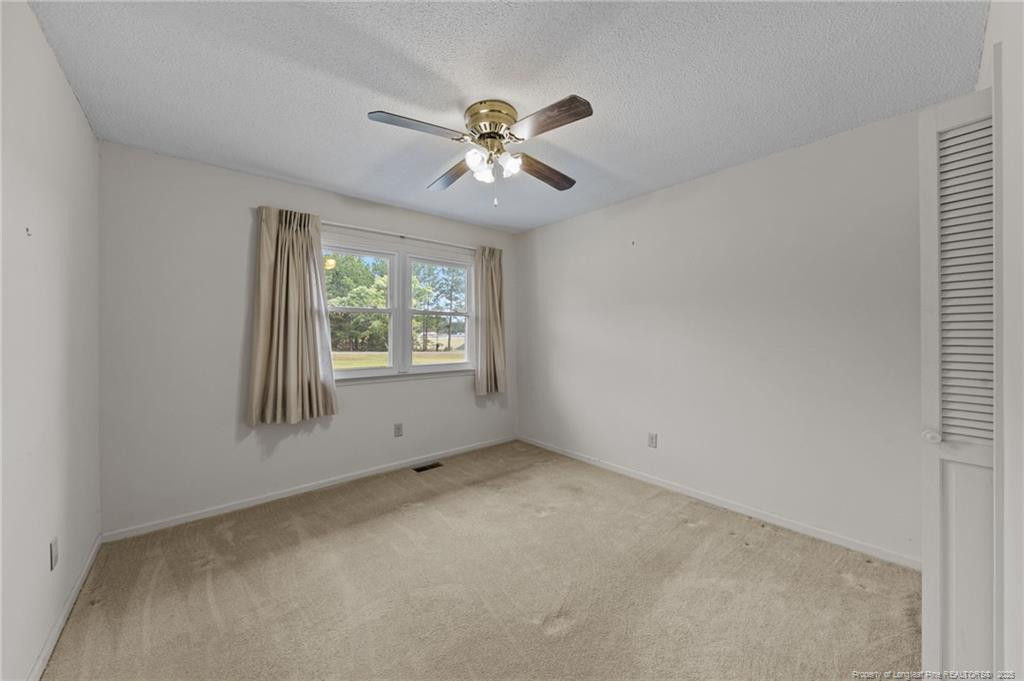 241 Hight Road Aberdeen, NC 28315 - Photo 17 of 48 an empty room with a window and a fan