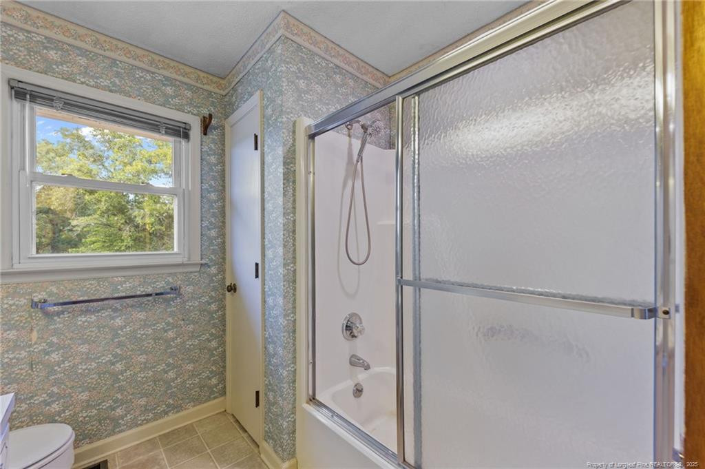241 Hight Road Aberdeen, NC 28315 - Photo 19 of 48 a bathroom with a glass shower door