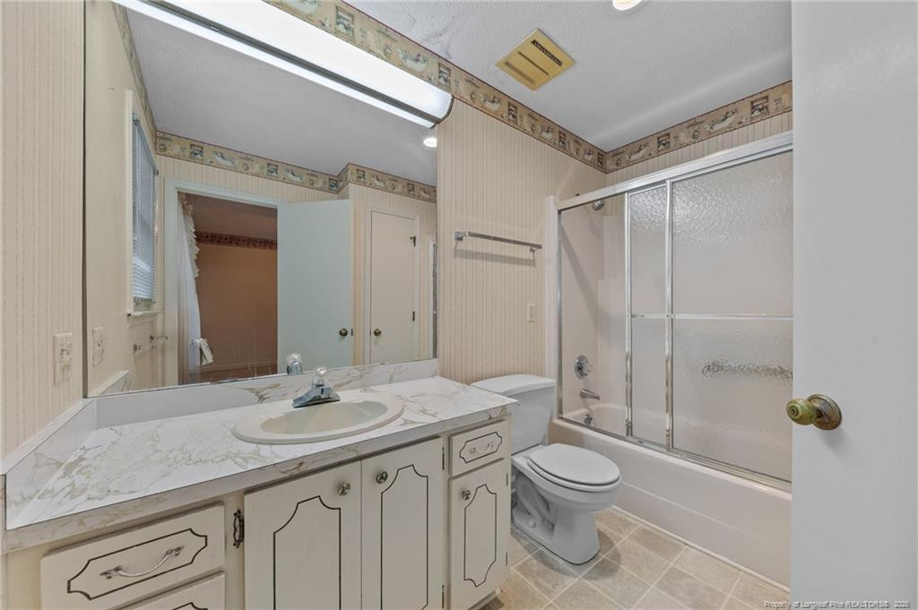 241 Hight Road Aberdeen, NC 28315 - Photo 23 of 48 a bathroom with a granite countertop sink a toilet and shower