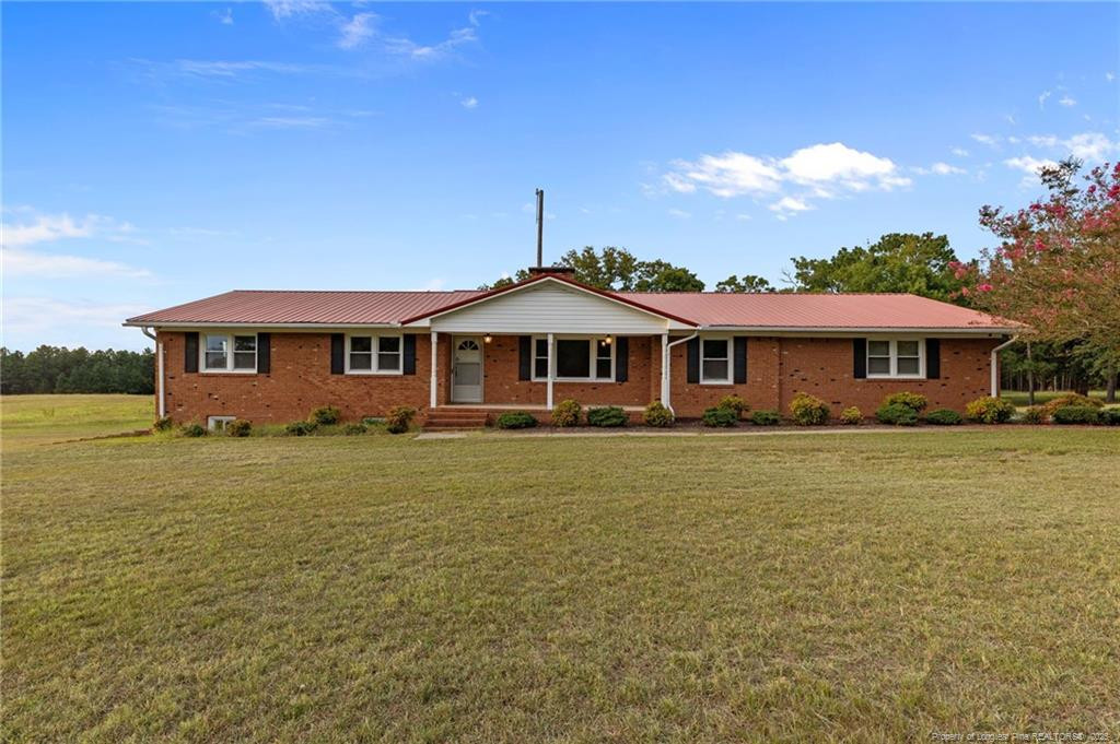 241 Hight Road Aberdeen, NC 28315 - Photo 47 of 48 a front view of a house with a garden
