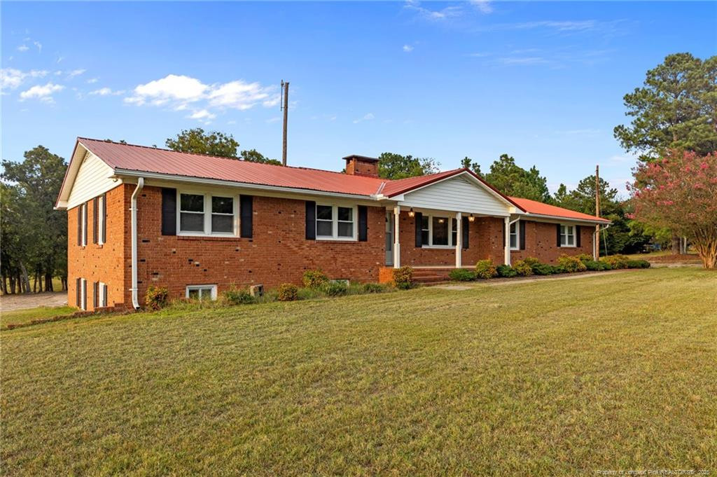 241 Hight Road Aberdeen, NC 28315 - Photo 48 of 48 a front view of a house with a garden