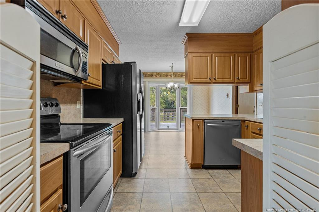 241 Hight Road Aberdeen, NC 28315 - Photo 7 of 48 a kitchen with stainless steel appliances granite countertop a refrigerator and a stove