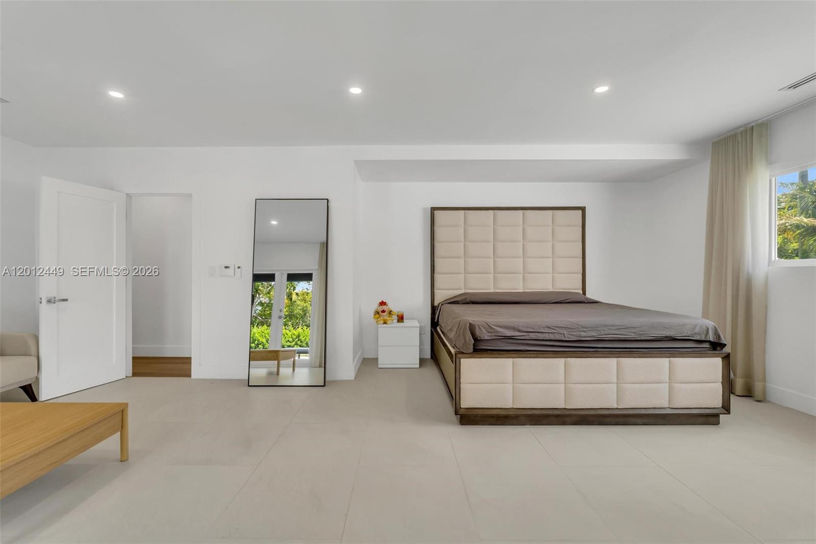 6200 Southwest 118th Street Pinecrest, FL 33156 - Photo 30 of 69 a spacious bedroom with a bed and a window