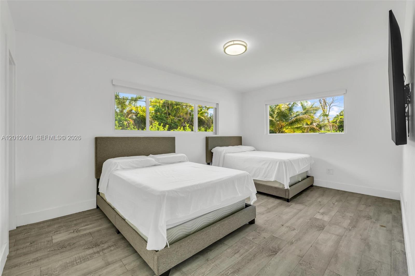6200 Southwest 118th Street Pinecrest, FL 33156 - Photo 39 of 69 a bed room with two beds and a painting on the wall