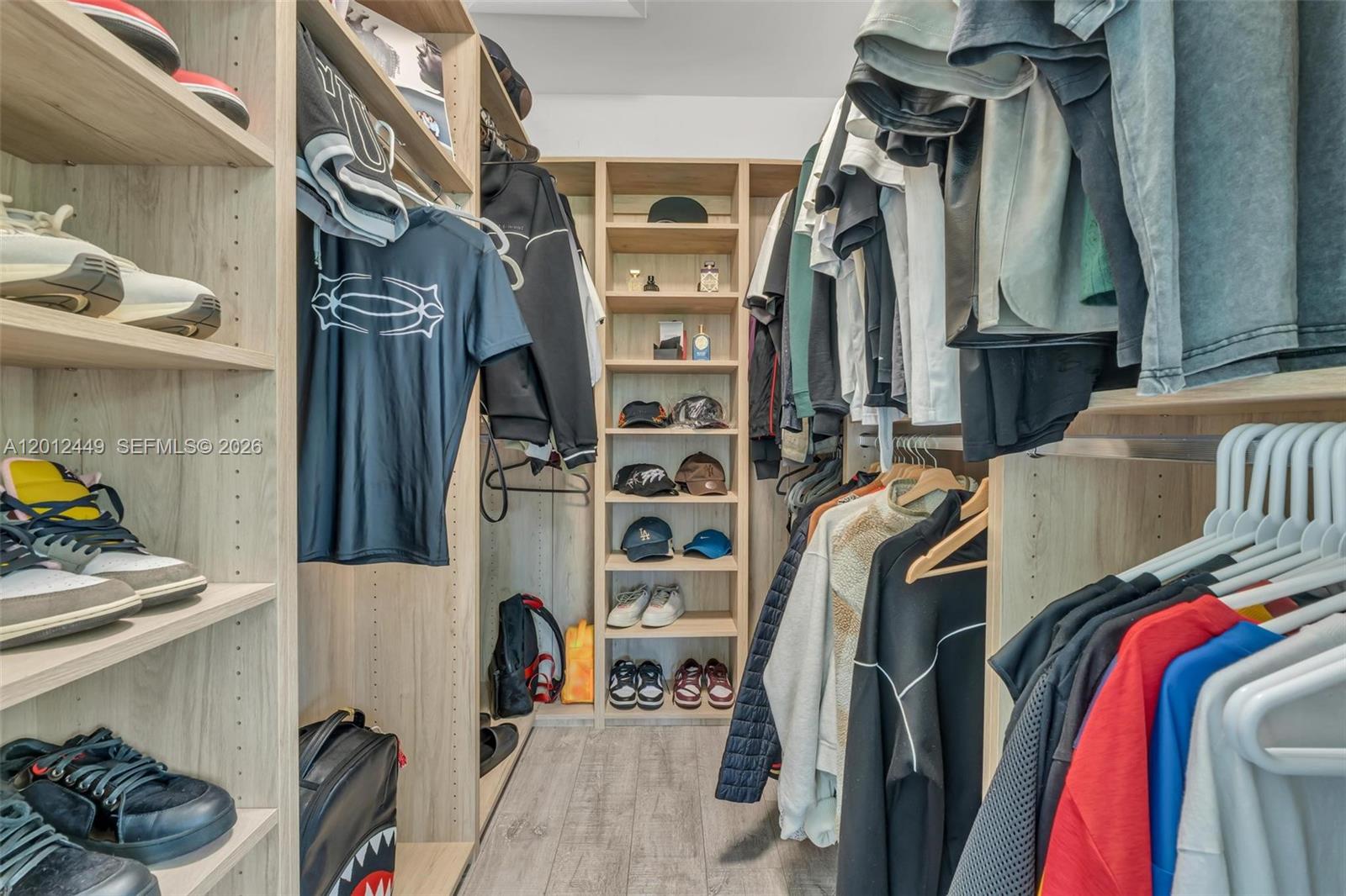 6200 Southwest 118th Street Pinecrest, FL 33156 - Photo 42 of 69 a view of walk in closet with clothes and shoes