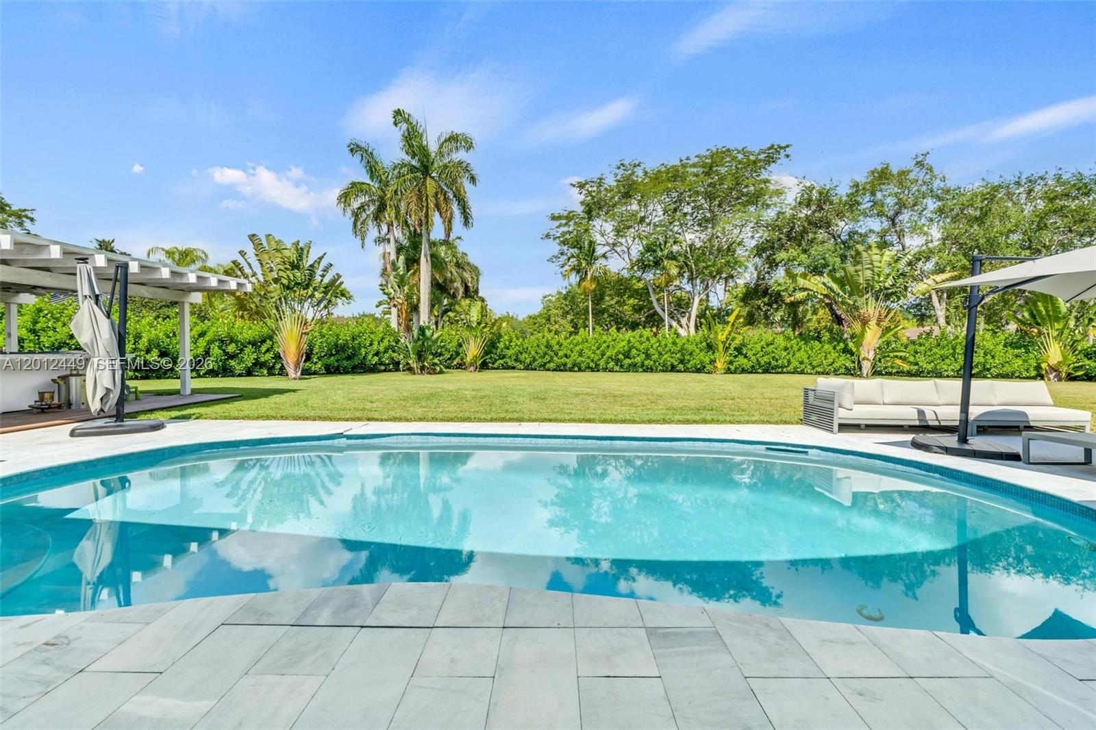 6200 Southwest 118th Street Pinecrest, FL 33156 - Photo 50 of 69 a view of a swimming pool and a yard