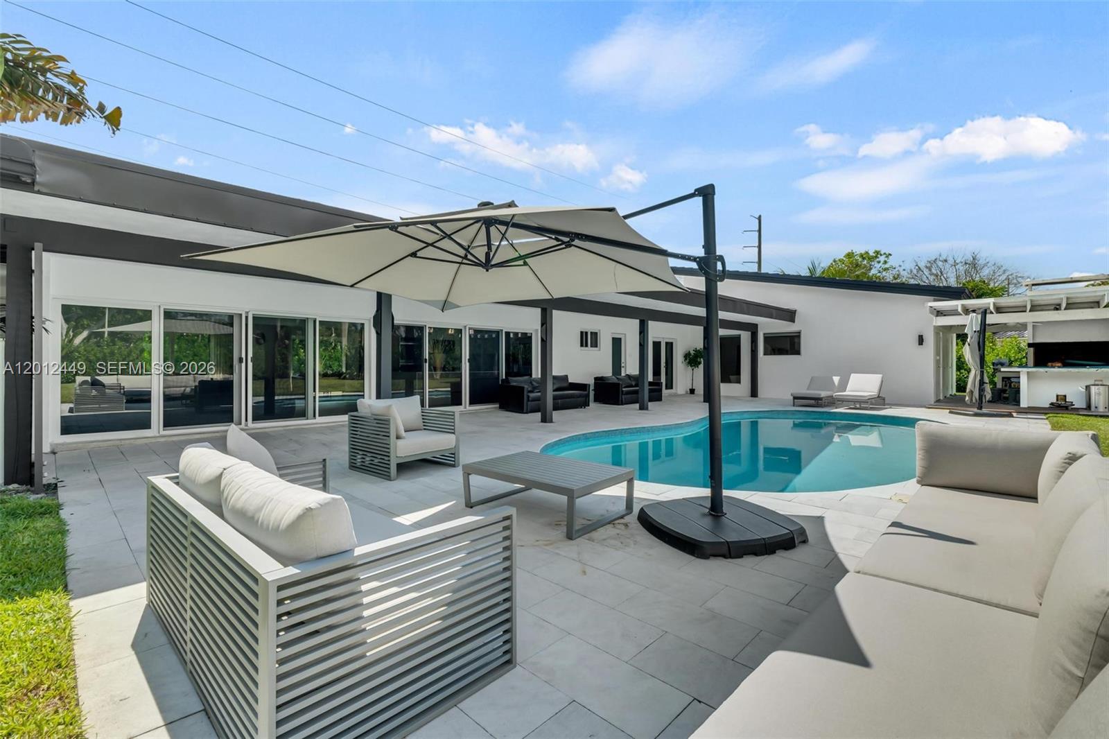 6200 Southwest 118th Street Pinecrest, FL 33156 - Photo 51 of 69 a view of a patio with couches chairs and a fire pit