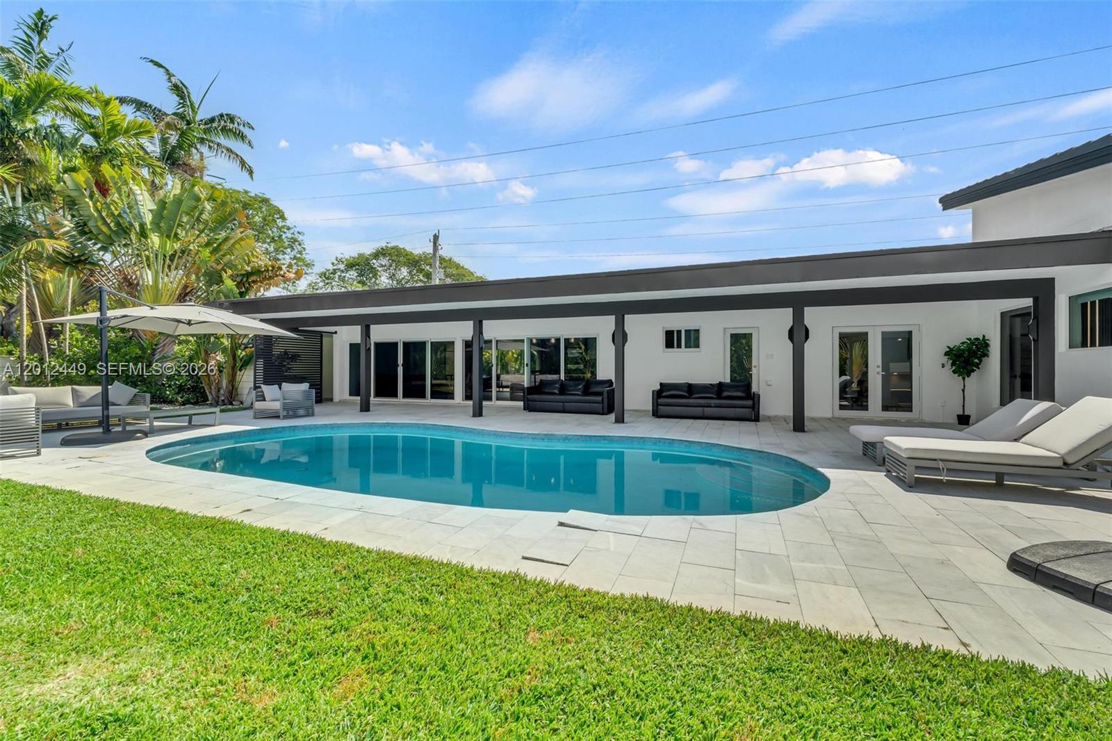 6200 Southwest 118th Street Pinecrest, FL 33156 - Photo 53 of 69 a view of house that has a swimming pool with a yard