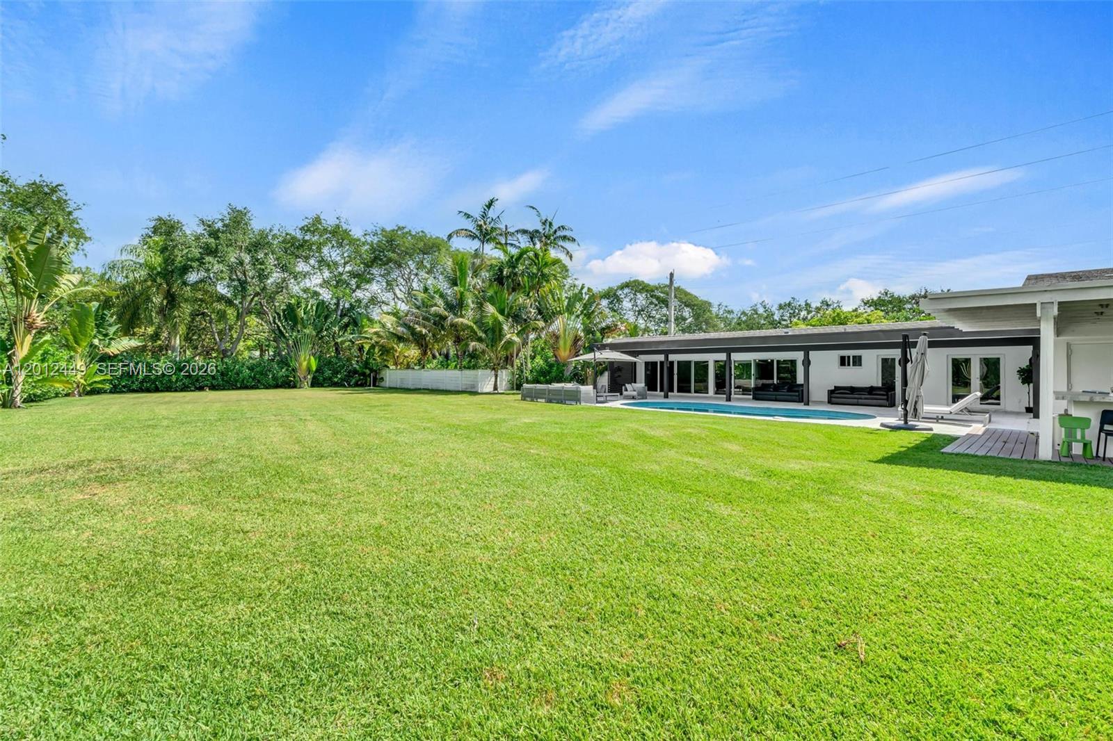 6200 Southwest 118th Street Pinecrest, FL 33156 - Photo 54 of 69 a front view of a house with a garden
