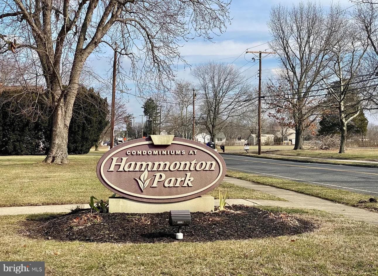 a sign board with a tub and trees