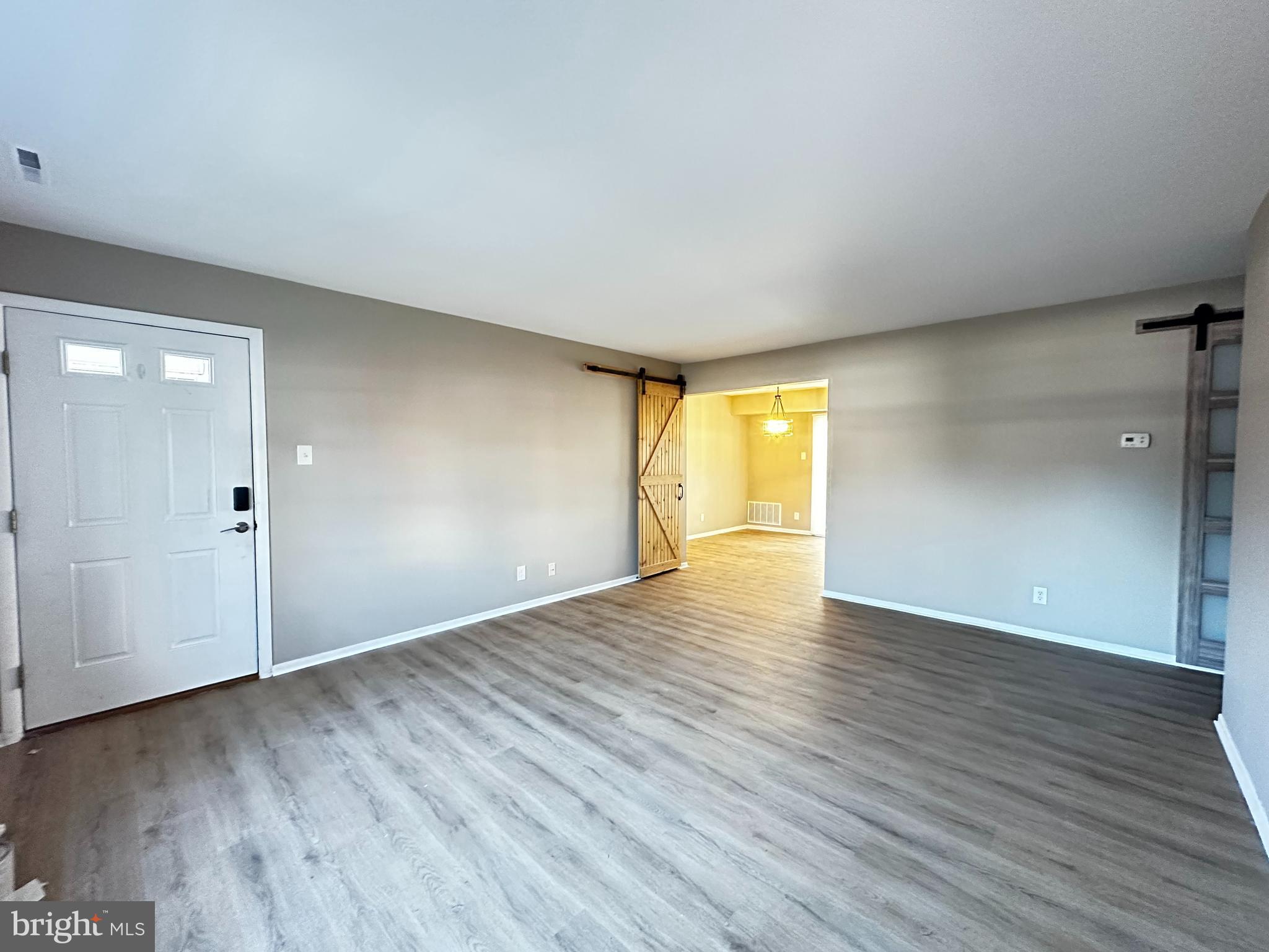 42 D Michael Road Hammonton, NJ 08037 - Photo 7 of 15 a view of an empty room with wooden floor and a window