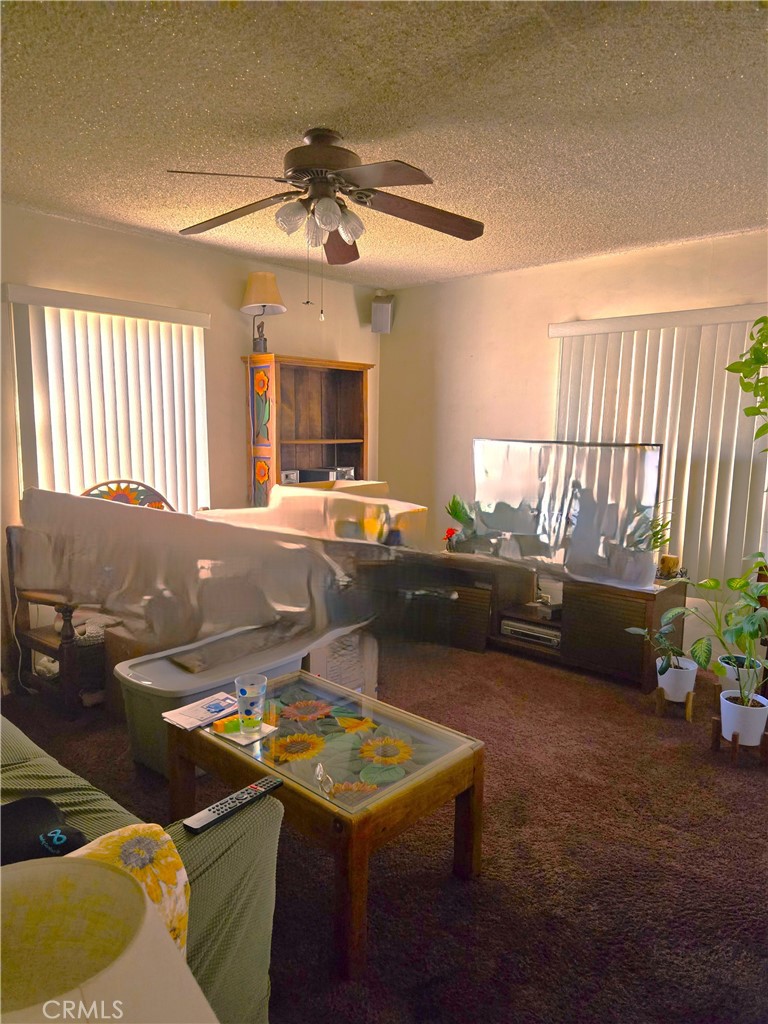 1538 Simmons Avenue Los Angeles, CA 90022 - Photo 5 of 11 a living room with furniture and a flat screen tv