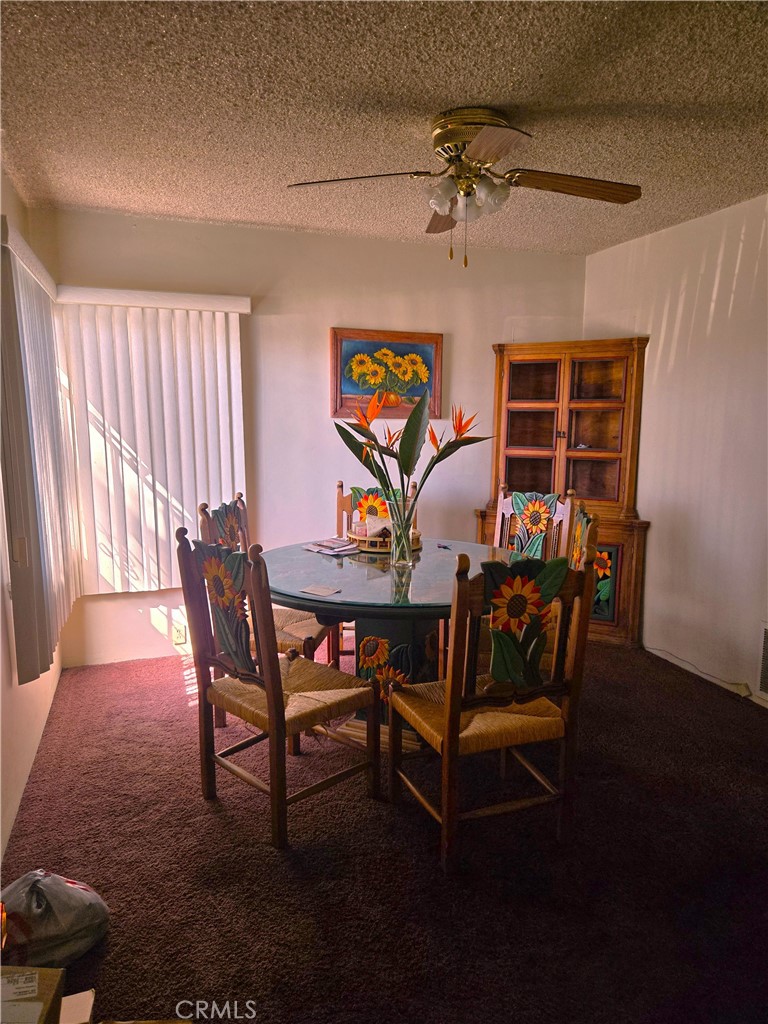 1538 Simmons Avenue Los Angeles, CA 90022 - Photo 6 of 11 a view of a dining room with furniture wooden floor and a chandelier