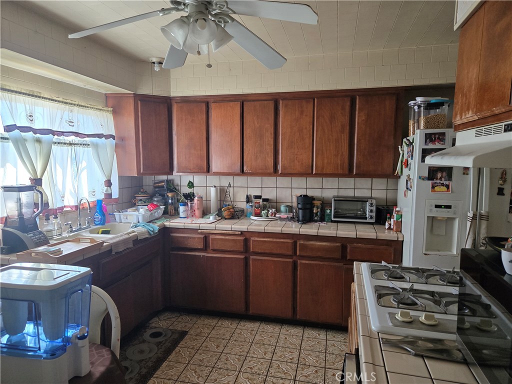 1538 Simmons Avenue Los Angeles, CA 90022 - Photo 7 of 11 a kitchen with a sink stove and cabinets