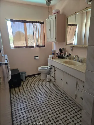 a bathroom with a sink toilet and mirror