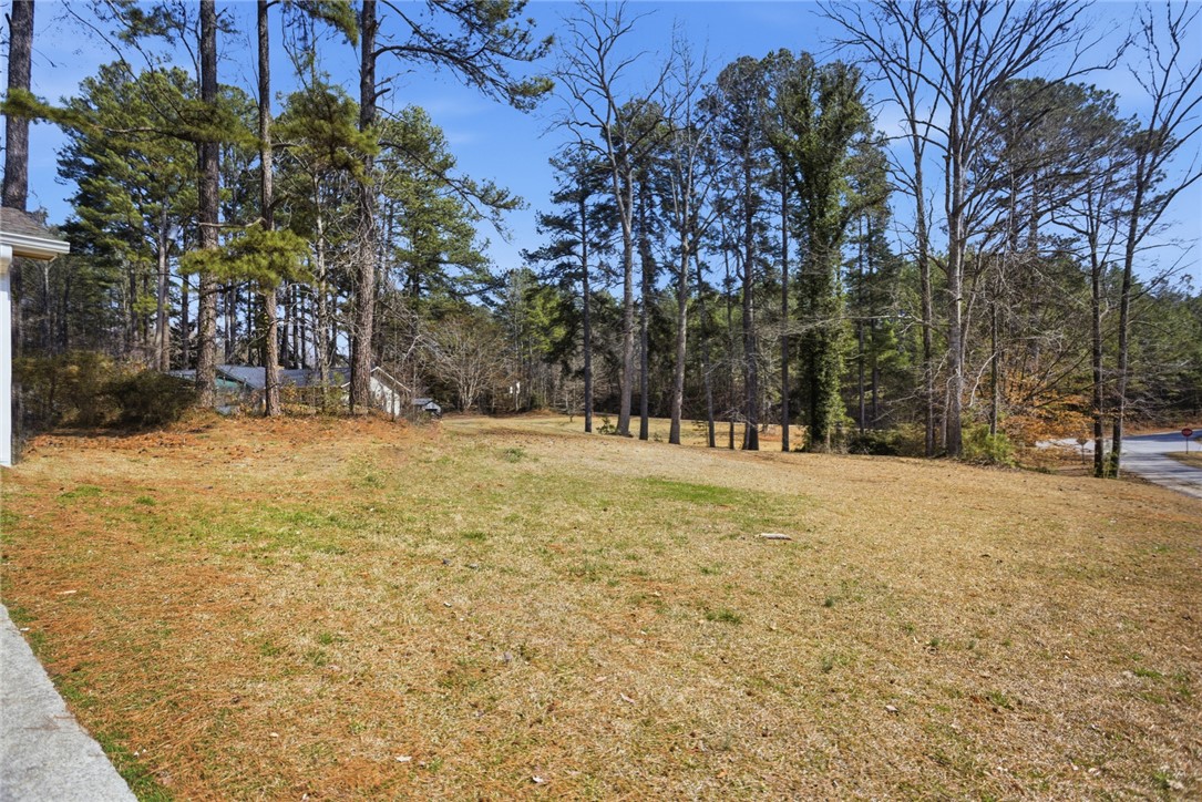 308 Wildwood Road Walhalla, SC 29691 - Photo 2 of 23 This spacious yard offers a serene setting with mature trees and ample outdoor space.