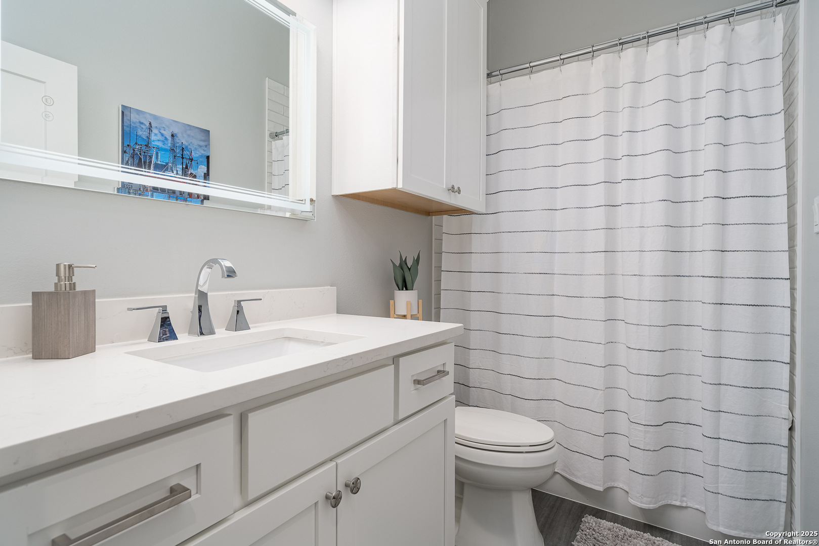 107 Windjammer Road Rockport, TX 78382 - Photo 18 of 52 a bathroom with a sink a toilet and shower curtain
