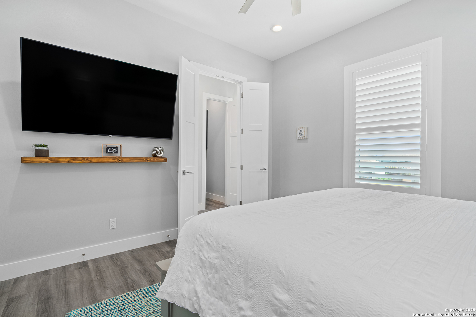 107 Windjammer Road Rockport, TX 78382 - Photo 23 of 52 a bedroom with a bed and a flat screen tv