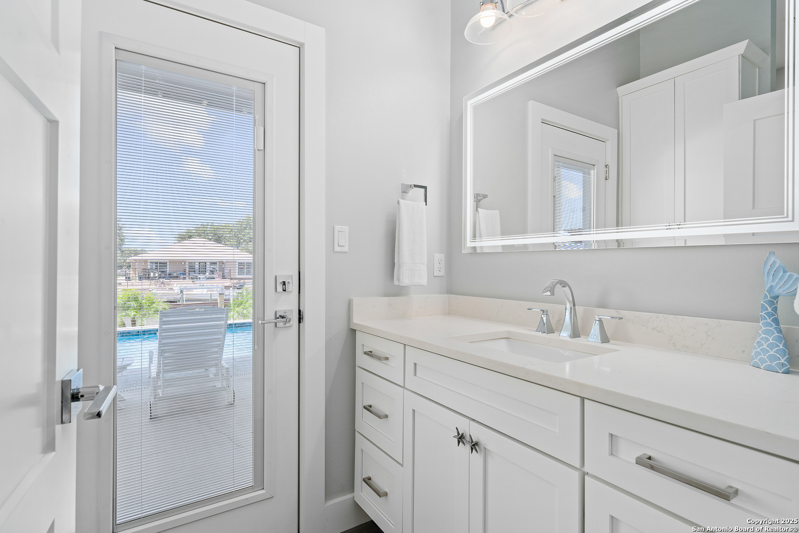 107 Windjammer Road Rockport, TX 78382 - Photo 25 of 52 a bathroom with a sink and a mirror