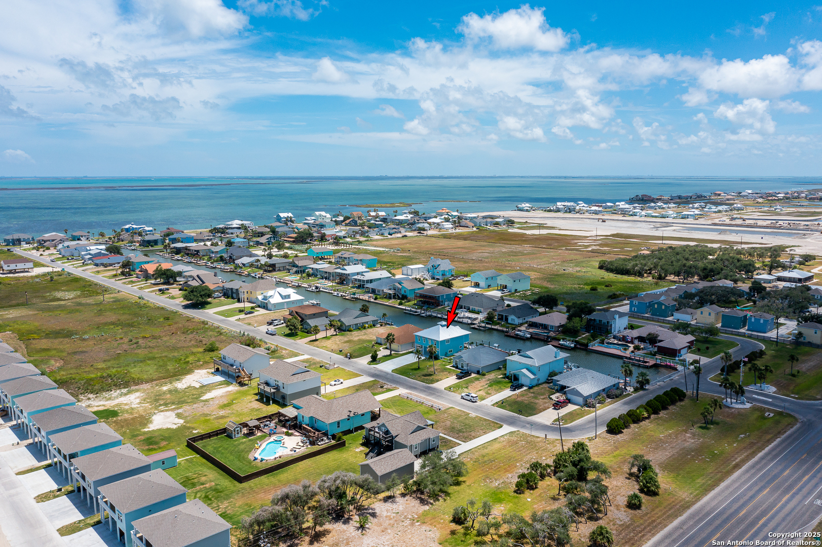 107 Windjammer Road Rockport, TX 78382 - Photo 32 of 52 an aerial view of a city with lots of residential buildings and ocean view in back