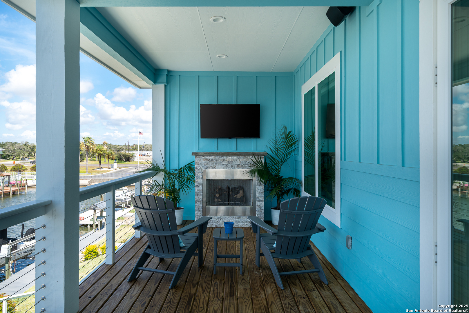 107 Windjammer Road Rockport, TX 78382 - Photo 45 of 52 a living room with furniture a flat screen tv and a fireplace