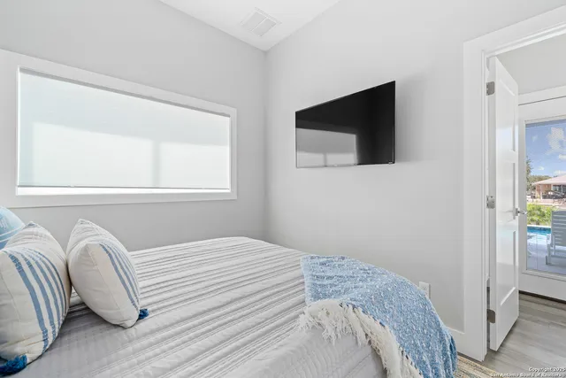 an aerial view of ocean and residential houses with outdoor space