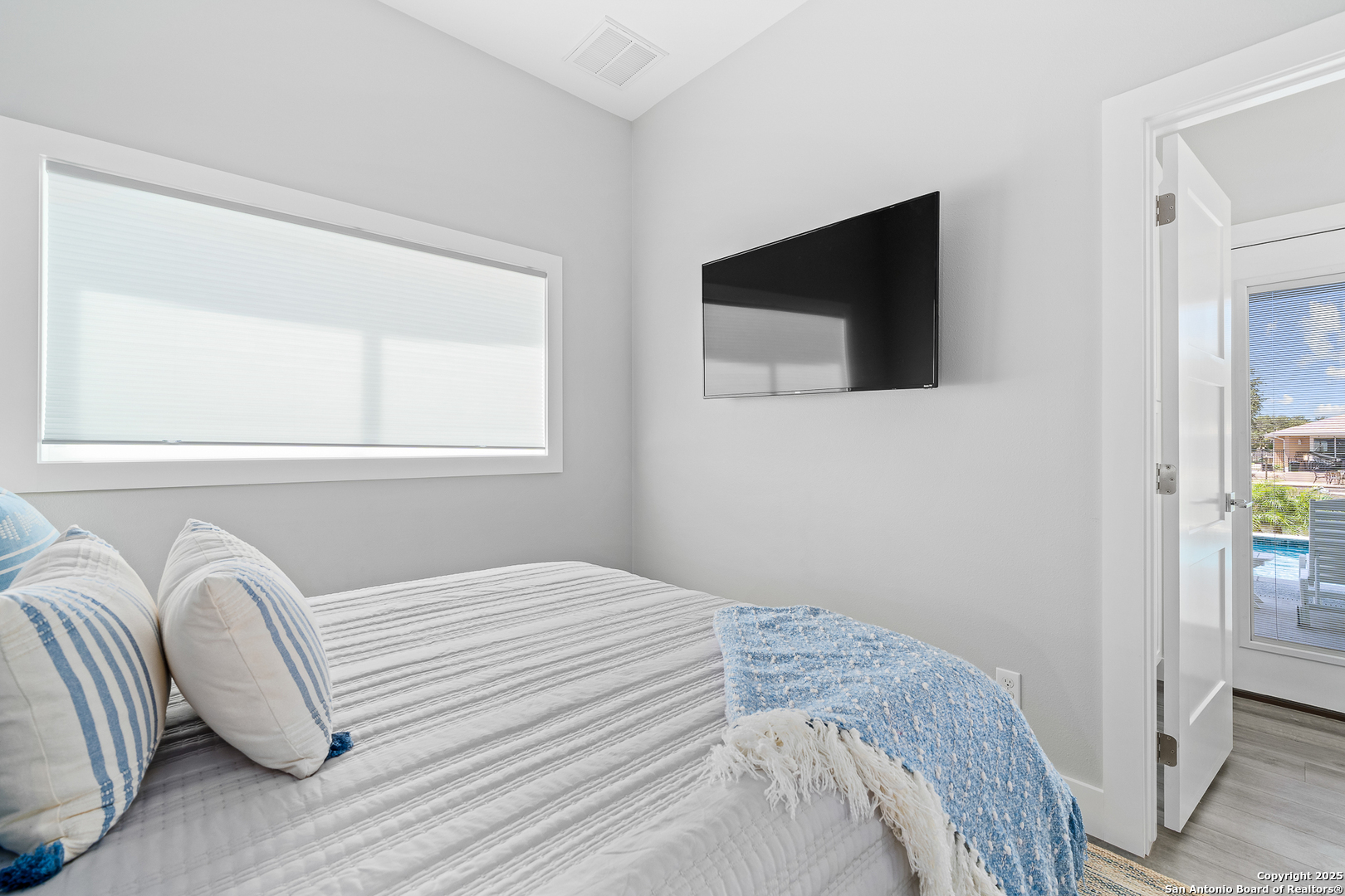 107 Windjammer Road Rockport, TX 78382 - Photo 48 of 52 a bedroom with a bed and a flat screen tv