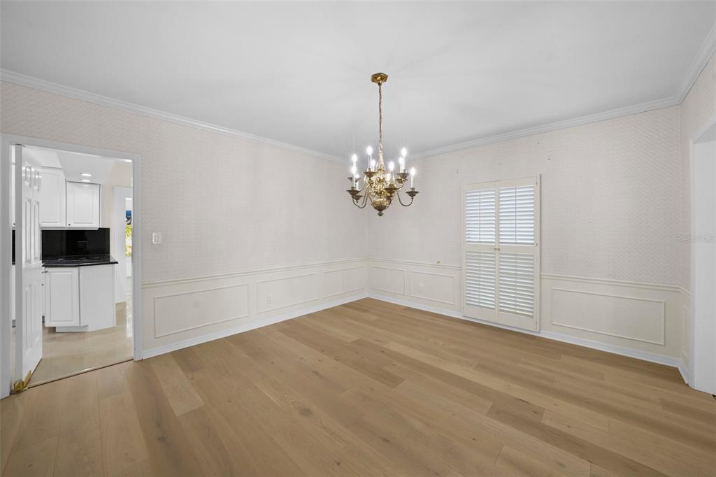 4913 Andros Drive Tampa, FL 33629 - Photo 11 of 57 a view of an empty room with chandelier and kitchen