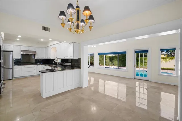 a living room with pool table and a large window