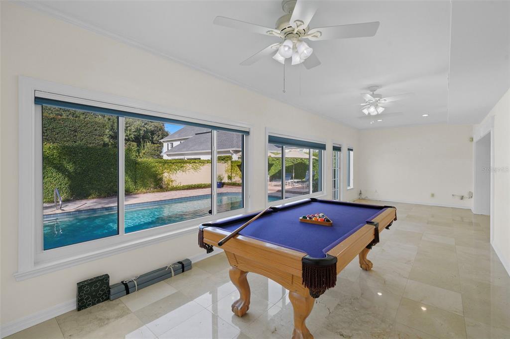 4913 Andros Drive Tampa, FL 33629 - Photo 17 of 57 a living room with pool table and a large window