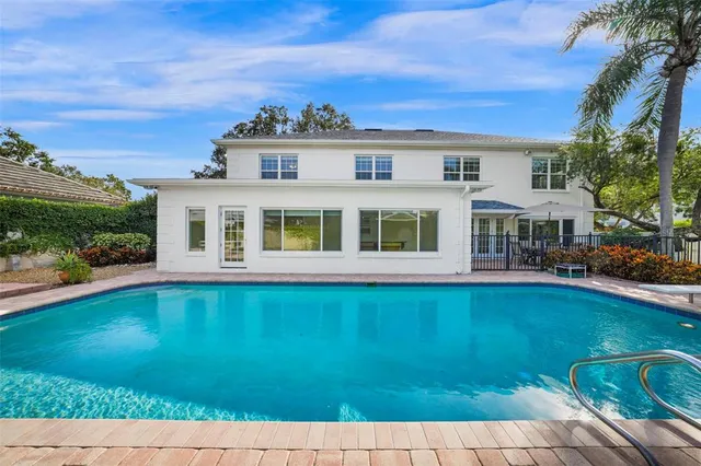 a view of empty room with wooden floor and ceiling fan