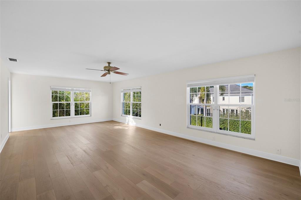 4913 Andros Drive Tampa, FL 33629 - Photo 28 of 57 a view of an empty room with wooden floor and a window