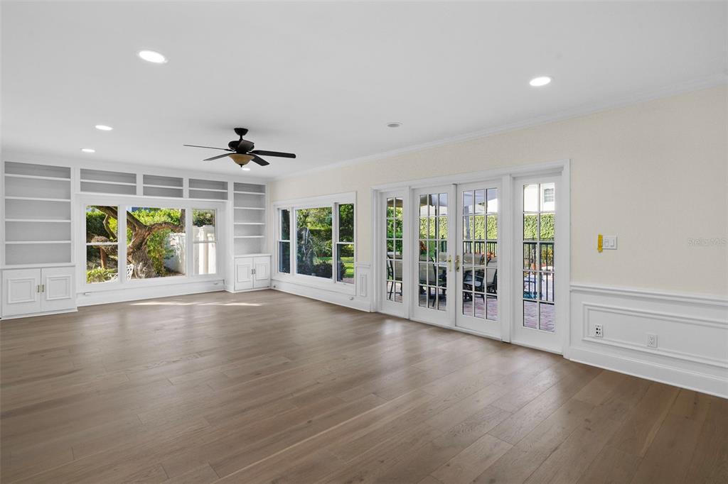 4913 Andros Drive Tampa, FL 33629 - Photo 3 of 57 an empty room with floor to ceiling window and wooden floor