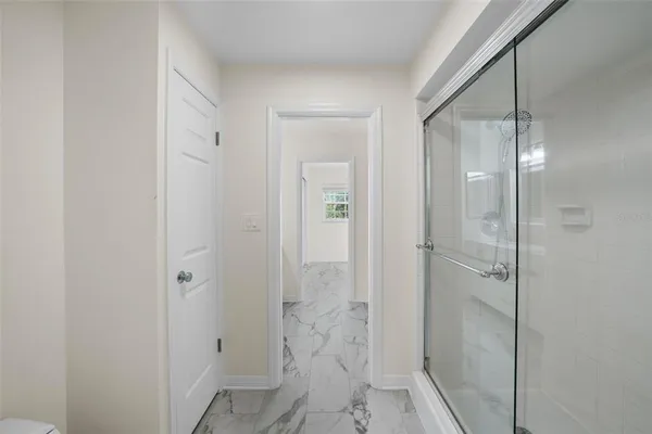 a spacious bathroom with a granite countertop sink a toilet and a mirror