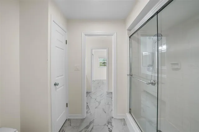 a spacious bathroom with a granite countertop sink a toilet and a mirror
