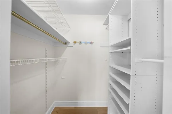 a view of a white house with a big yard and large trees