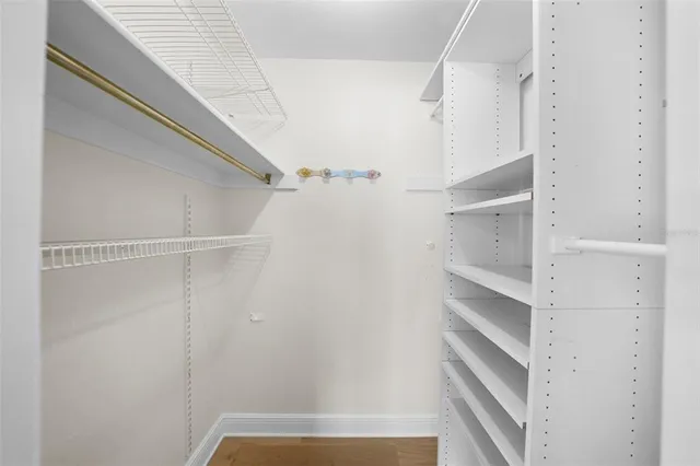 a view of a white house with a big yard and large trees