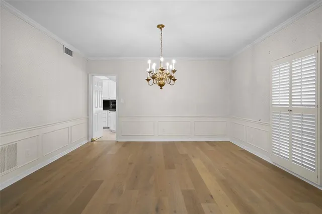 a view of a room with wooden floor and window
