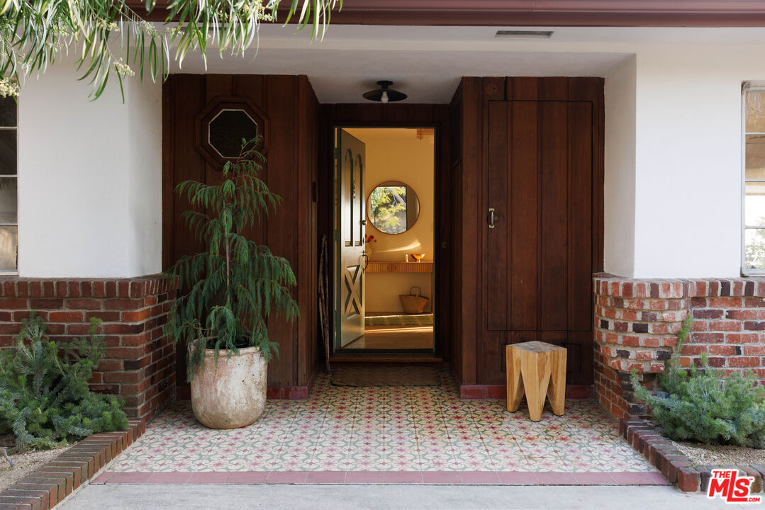 a view of a entryway door of the house and living room