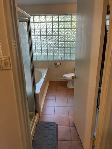 a bathroom with a sink a toilet and a shower